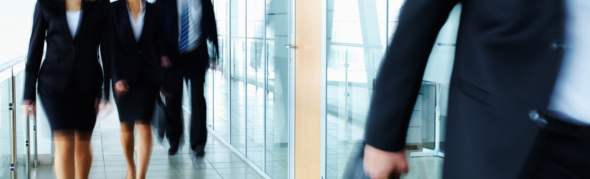 Business professionals walking through an office corridor